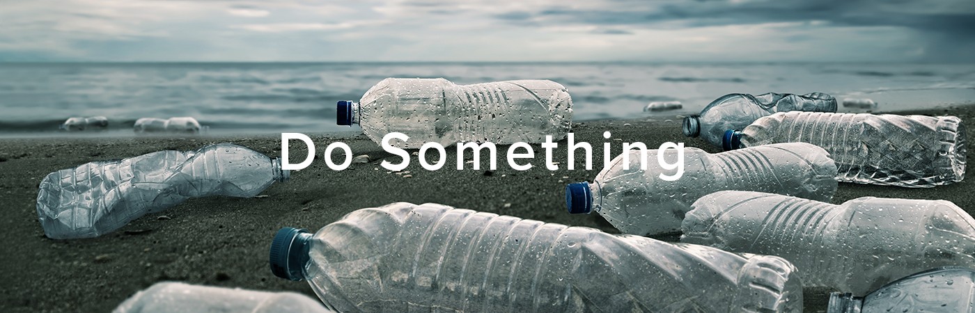 A photograph of a beach littered with plastic bottles, covered with the words "Do Something." Photo credit: chaiyapruek2520