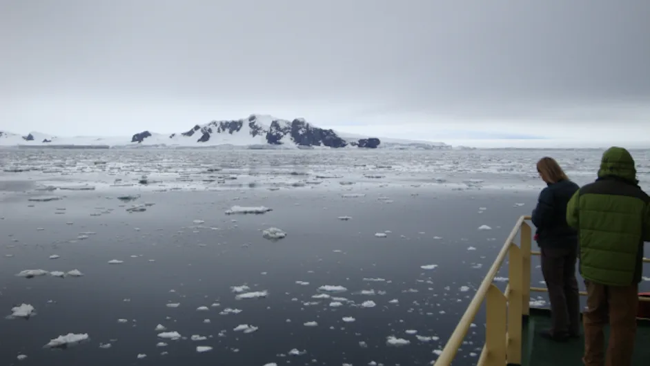 Ice filled water with snow covered mountain in the background