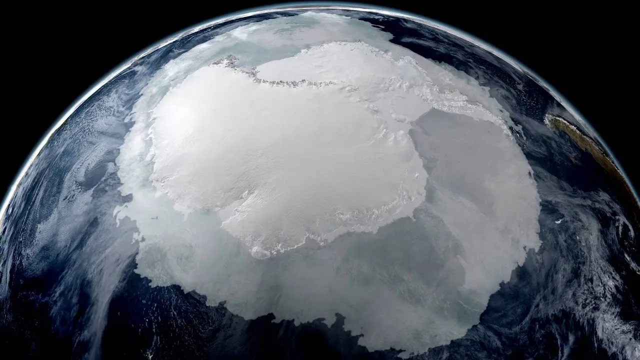 Global shaped image of Earth showing white patches of melting ice and blue water