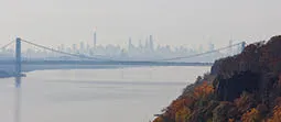 Body of water with bridge and city in the background.