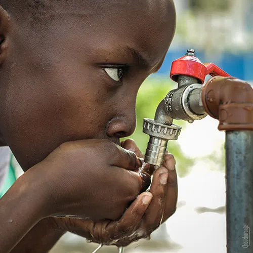 Child drinking from a tap